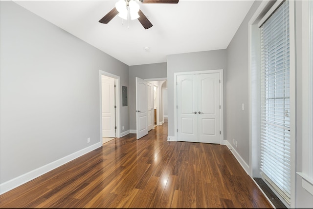 307 Seven Springs Way Unit 103, Brentwood, TN 37027 - unfurnished bedroom with dark wood-type flooring, electric panel, a ceiling fan, and a closet