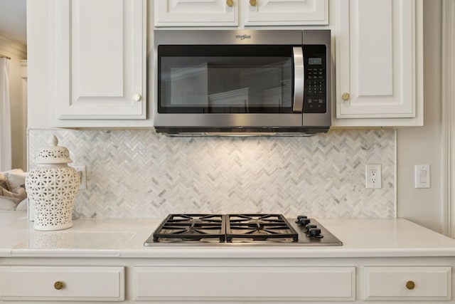 216 Bramerton Ct, Franklin, TN 37069 - kitchen featuring appliances with stainless steel finishes, light countertops, backsplash, and white cabinetry