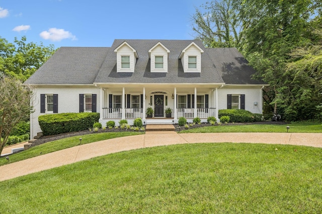 216 Bramerton Ct, Franklin, TN 37069 - new england style home featuring covered porch, brick siding, a front lawn, and a shingled roof