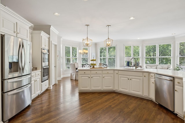 216 Bramerton Ct, Franklin, TN 37069 - kitchen featuring appliances with stainless steel finishes, dark wood-style floors, crown molding, white cabinetry, and recessed lighting