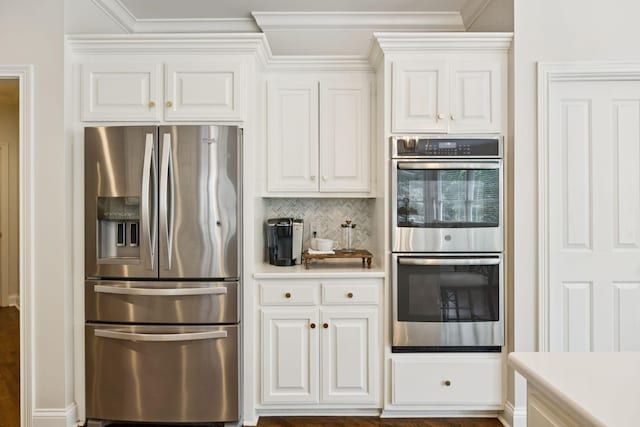 216 Bramerton Ct, Franklin, TN 37069 - kitchen featuring appliances with stainless steel finishes, white cabinetry, light countertops, decorative backsplash, and crown molding
