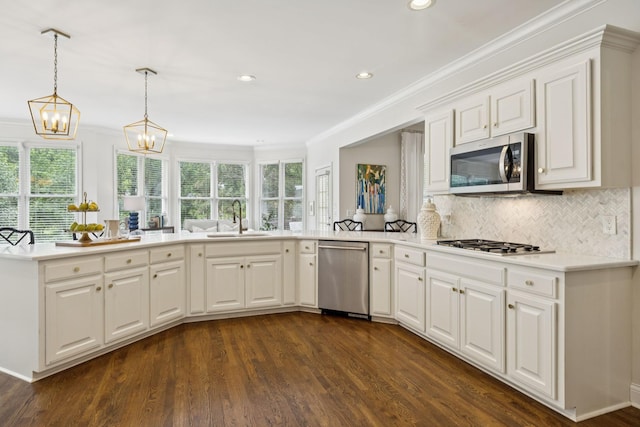 216 Bramerton Ct, Franklin, TN 37069 - kitchen with stainless steel appliances, ornamental molding, light countertops, dark wood-style floors, and recessed lighting