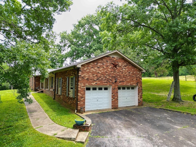 1094B Center Point Rd, Hendersonville, TN 37075 - view of home's exterior with driveway, a yard, a garage, and brick siding