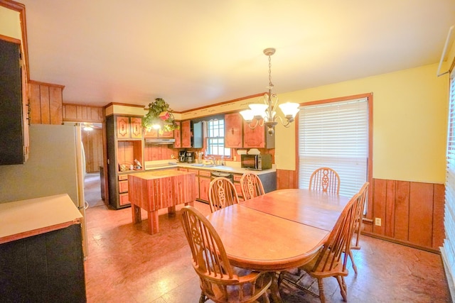 1094B Center Point Rd, Hendersonville, TN 37075 - dining area featuring a chandelier, wooden walls, a wainscoted wall, and light floors