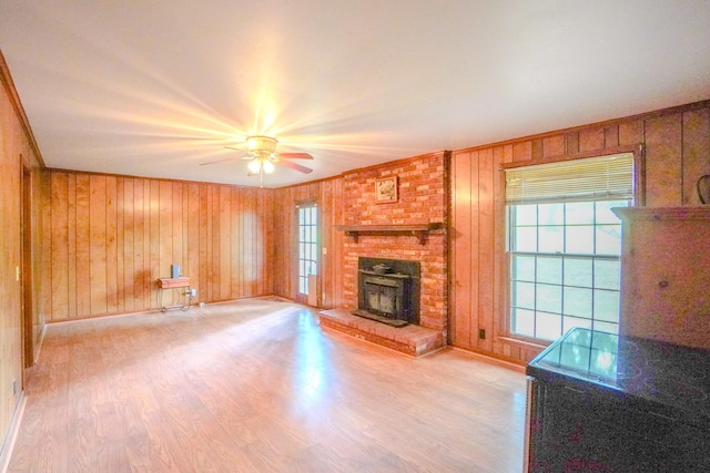 1094B Center Point Rd, Hendersonville, TN 37075 - unfurnished living room featuring crown molding, light wood-style floors, healthy amount of natural light, wood walls, and a brick fireplace