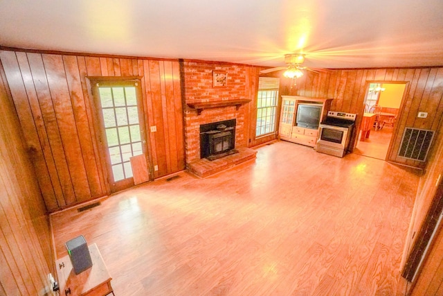 1094B Center Point Rd, Hendersonville, TN 37075 - unfurnished living room featuring a brick fireplace, a ceiling fan, wood walls, and wood finished floors