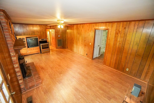 1094B Center Point Rd, Hendersonville, TN 37075 - unfurnished living room featuring a ceiling fan, wood walls, light wood-style floors, and a brick fireplace