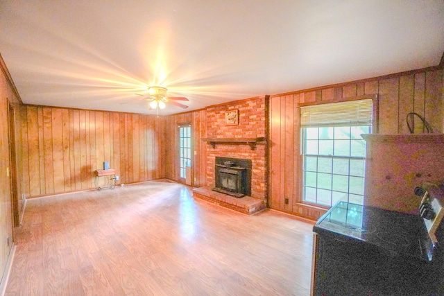 1094B Center Point Rd, Hendersonville, TN 37075 - unfurnished living room featuring a brick fireplace, crown molding, ceiling fan, light wood-style floors, and wood walls