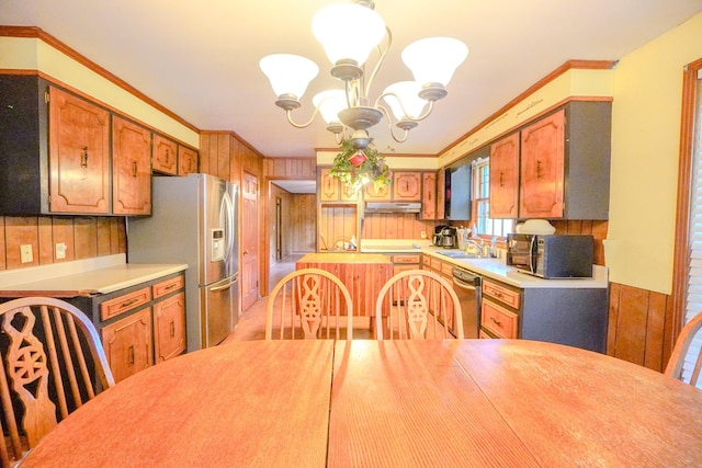 1094B Center Point Rd, Hendersonville, TN 37075 - kitchen featuring appliances with stainless steel finishes, a chandelier, under cabinet range hood, light countertops, and wooden walls