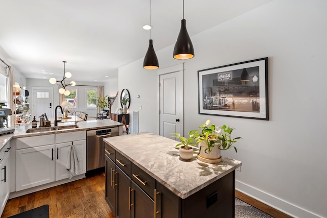 1708A 7th Ave N, Nashville, TN 37208 - kitchen with stainless steel dishwasher, dark wood-type flooring, a center island, pendant lighting, and light stone countertops
