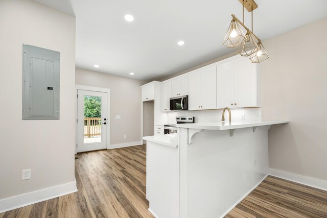223 Patriot Ln, Estill Springs, TN 37330 - kitchen with electric panel, stainless steel appliances, light countertops, white cabinets, and light wood-type flooring