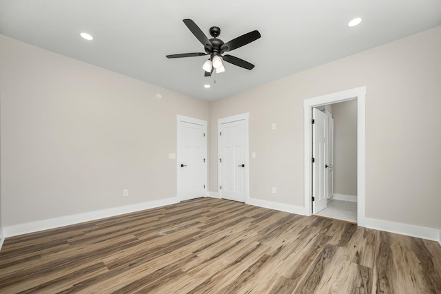 223 Patriot Ln, Estill Springs, TN 37330 - unfurnished bedroom featuring wood finished floors, recessed lighting, a ceiling fan, and connected bathroom