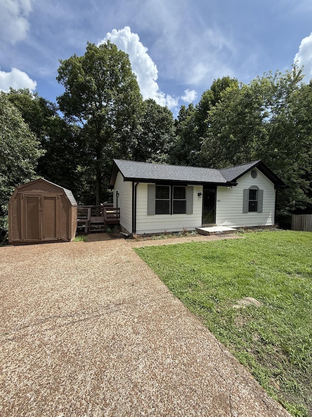 1012 Hollis Ln, White House, TN 37188 - view of front of home with a shed, a front yard, roof with shingles, and view of scattered trees