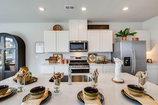 1752 Wren Way, Lebanon, TN 37087 - kitchen featuring stainless steel appliances, light countertops, white cabinetry, and recessed lighting