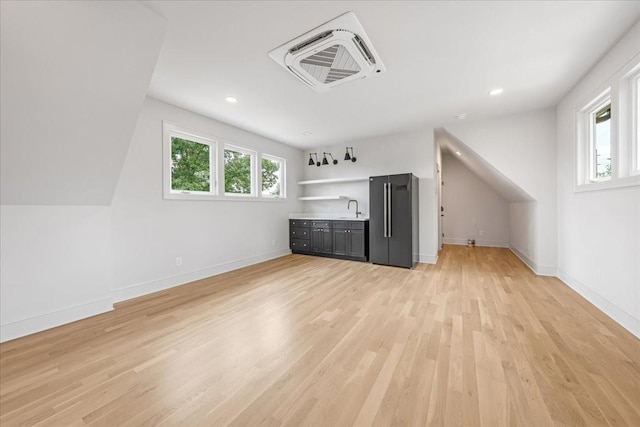 1516 Forest Ave, Nashville, TN 37206 - additional living space with light wood-style flooring, plenty of natural light, bar with sink, and recessed lighting