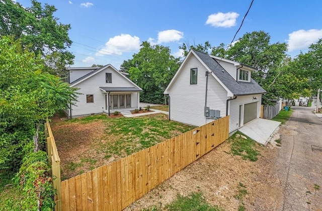 1516 Forest Ave, Nashville, TN 37206 - view of property exterior featuring concrete driveway, roof with shingles, and a garage