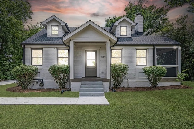 1516 Forest Ave, Nashville, TN 37206 - view of front of property featuring a front yard, a chimney, roof with shingles, and brick siding