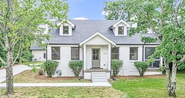 1516 Forest Ave, Nashville, TN 37206 - cape cod home featuring a front yard and a shingled roof