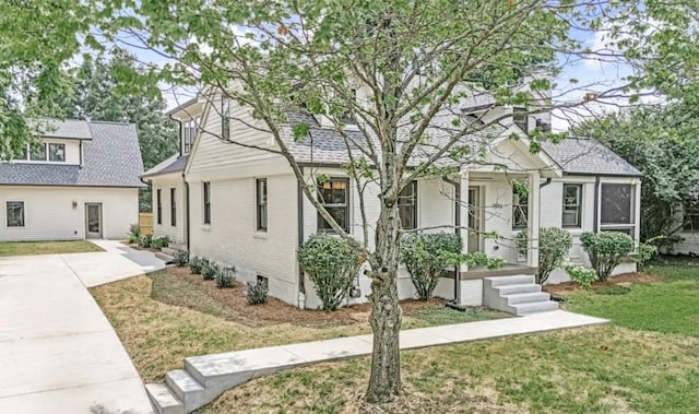 1516 Forest Ave, Nashville, TN 37206 - view of front facade featuring a front lawn, a porch, and brick siding