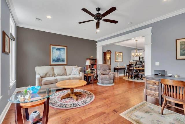 4313 Glasgow Rd, Spring Hill, TN 37174 - living area featuring wood finished floors, ceiling fan, ornate columns, a chandelier, and crown molding