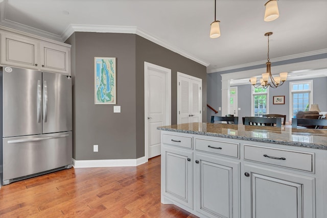4313 Glasgow Rd, Spring Hill, TN 37174 - kitchen featuring freestanding refrigerator, light wood-style floors, crown molding, pendant lighting, and a chandelier