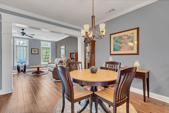 4313 Glasgow Rd, Spring Hill, TN 37174 - dining room with wood finished floors, ornamental molding, decorative columns, a ceiling fan, and a chandelier