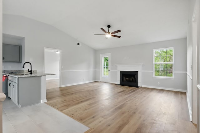 2717 Cayuga Dr, Murfreesboro, TN 37130 - unfurnished living room with vaulted ceiling, a ceiling fan, healthy amount of natural light, and light wood-type flooring