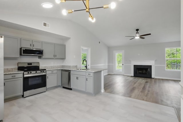 2717 Cayuga Dr, Murfreesboro, TN 37130 - kitchen featuring stainless steel appliances, gray cabinetry, lofted ceiling, and plenty of natural light