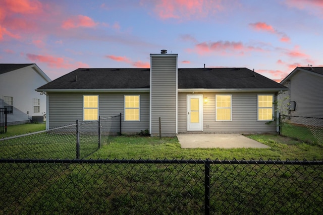 2717 Cayuga Dr, Murfreesboro, TN 37130 - back of property at dusk featuring a patio area, a fenced backyard, and a chimney