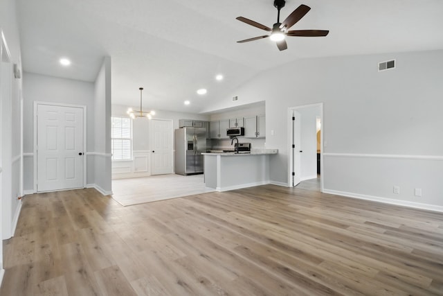 2717 Cayuga Dr, Murfreesboro, TN 37130 - unfurnished living room with ceiling fan, lofted ceiling, light wood-type flooring, a chandelier, and recessed lighting