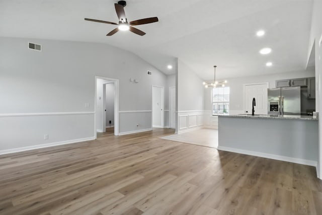 2717 Cayuga Dr, Murfreesboro, TN 37130 - unfurnished living room with a chandelier, lofted ceiling, a ceiling fan, light wood-style flooring, and recessed lighting