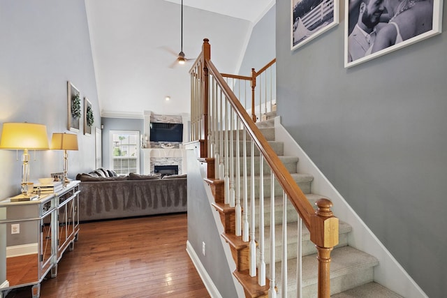2507 Patricia Cir, Murfreesboro, TN 37128 - stairway featuring a fireplace, hardwood / wood-style flooring, high vaulted ceiling, and ceiling fan