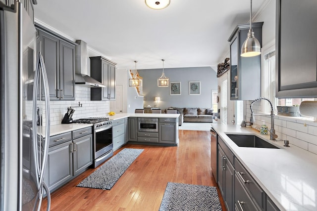 2507 Patricia Cir, Murfreesboro, TN 37128 - kitchen with appliances with stainless steel finishes, wall chimney range hood, gray cabinets, open floor plan, and tasteful backsplash