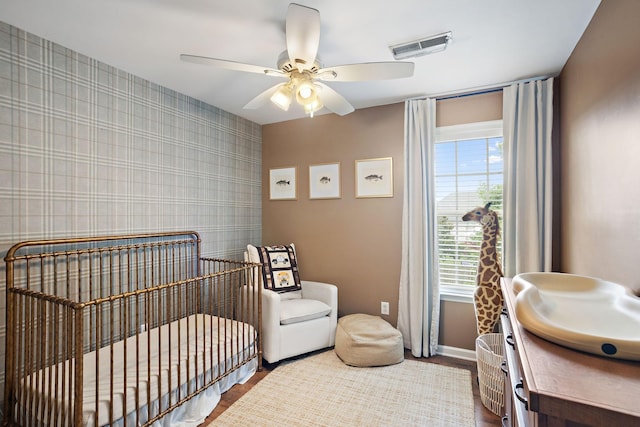 2507 Patricia Cir, Murfreesboro, TN 37128 - bedroom with wallpapered walls, wood finished floors, a nursery area, and a ceiling fan