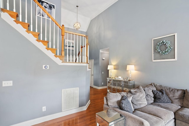 2507 Patricia Cir, Murfreesboro, TN 37128 - living area featuring stairs, ornamental molding, wood finished floors, a chandelier, and high vaulted ceiling