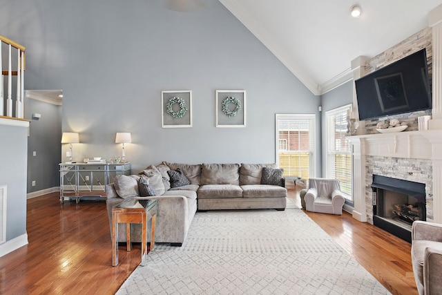 2507 Patricia Cir, Murfreesboro, TN 37128 - living area featuring high vaulted ceiling, a stone fireplace, wood finished floors, and crown molding