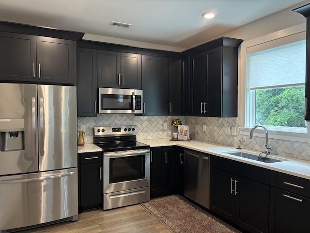 801 Cherokee Ave Apt 6, Nashville, TN 37207 - kitchen with stainless steel appliances, dark cabinets, light countertops, backsplash, and recessed lighting