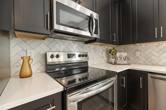 801 Cherokee Ave Apt 6, Nashville, TN 37207 - kitchen featuring stainless steel appliances, dark cabinetry, light countertops, and backsplash