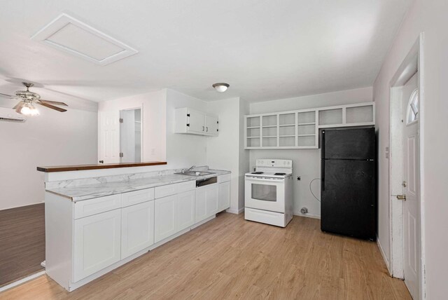 411 Lake Farm Rd, Smyrna, TN 37167 - kitchen featuring freestanding refrigerator, electric stove, a peninsula, light wood-style flooring, and white cabinetry