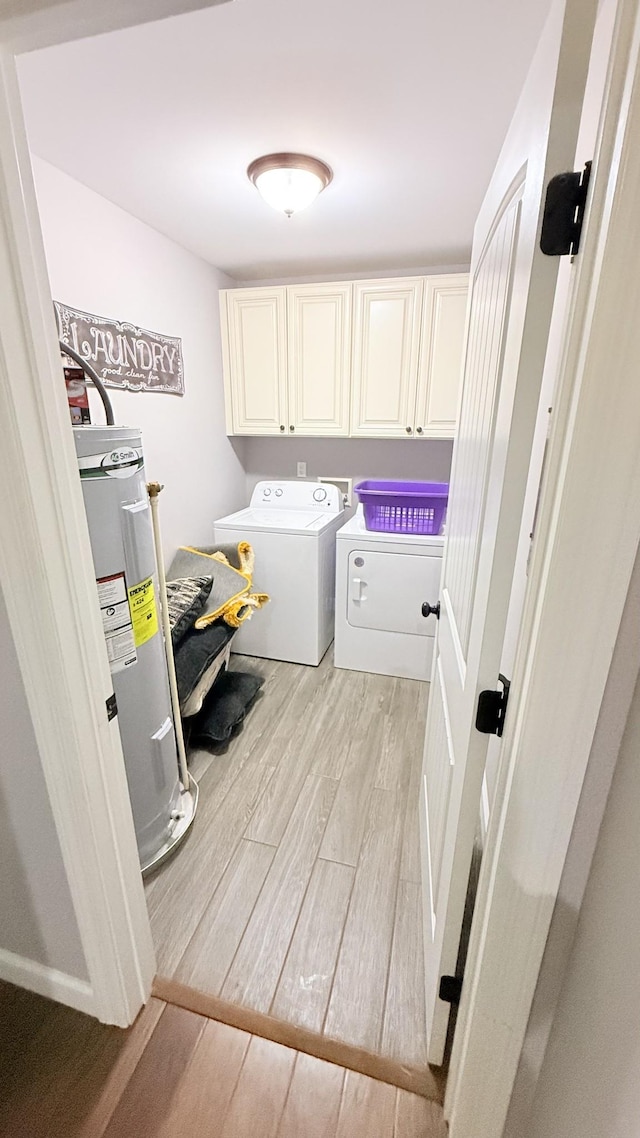 899 Sneed Blvd, Lafayette, TN 37083 - laundry area with cabinet space, electric water heater, light wood finished floors, and washing machine and dryer