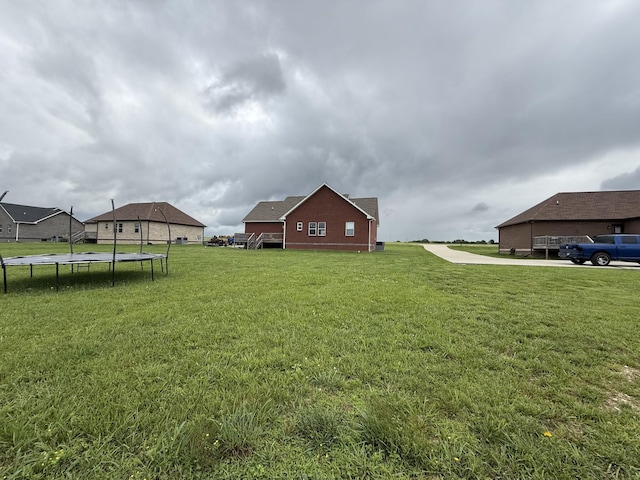 899 Sneed Blvd, Lafayette, TN 37083 - view of grassy yard featuring a trampoline