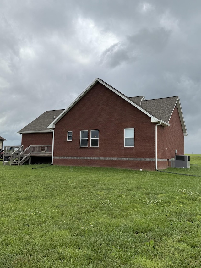 899 Sneed Blvd, Lafayette, TN 37083 - view of side of property featuring brick siding, a lawn, roof with shingles, and a wooden deck