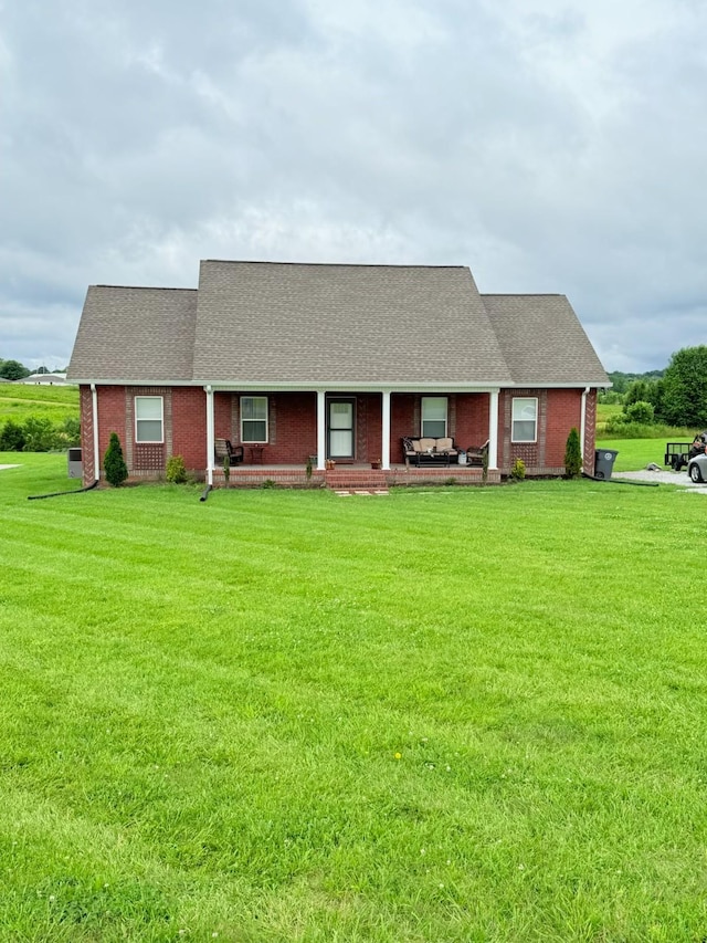 899 Sneed Blvd, Lafayette, TN 37083 - view of front of house featuring a front yard, a porch, brick siding, and roof with shingles