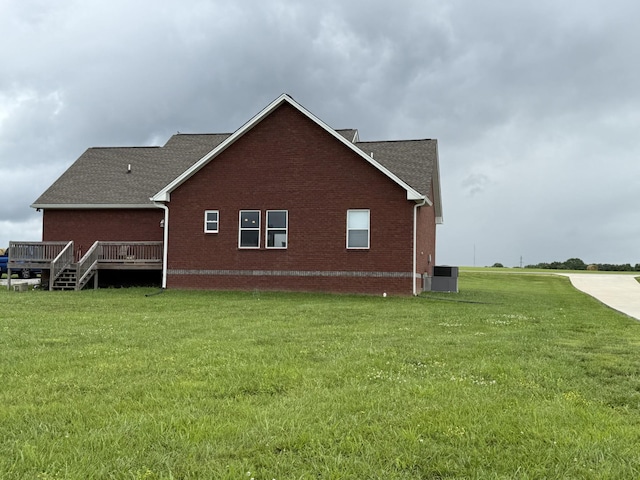899 Sneed Blvd, Lafayette, TN 37083 - view of property exterior featuring brick siding, a lawn, a wooden deck, and a shingled roof