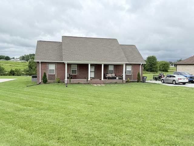 899 Sneed Blvd, Lafayette, TN 37083 - view of front facade featuring covered porch, a front lawn, roof with shingles, and brick siding