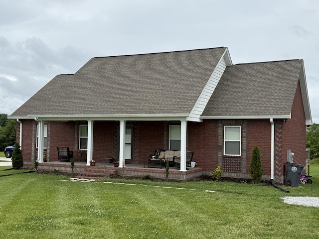 899 Sneed Blvd, Lafayette, TN 37083 - view of front facade featuring covered porch, roof with shingles, brick siding, and a front yard