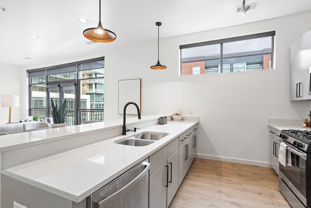 1002 Division St Unit 403, Nashville, TN 37203 - kitchen featuring stainless steel appliances, light wood-style floors, recessed lighting, light countertops, and a peninsula
