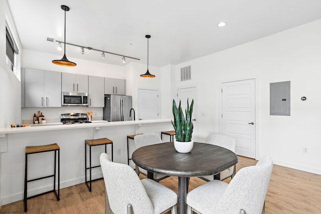 1002 Division St Unit 403, Nashville, TN 37203 - dining area featuring electric panel, light wood finished floors, rail lighting, and recessed lighting