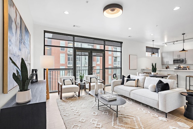 1002 Division St Unit 403, Nashville, TN 37203 - living room featuring light wood finished floors and recessed lighting