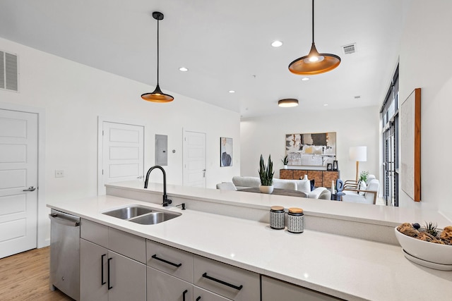 1002 Division St Unit 403, Nashville, TN 37203 - kitchen with dishwasher, light countertops, open floor plan, hanging light fixtures, and gray cabinetry